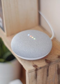 google home mini on brown board